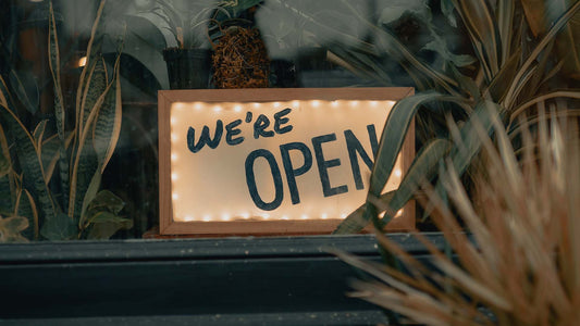 plant shop with we are open signage