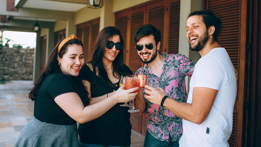 group of friends happily celebrating with a drink