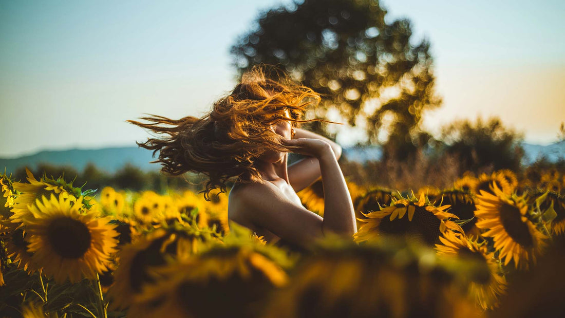 woman standing in sunflower field