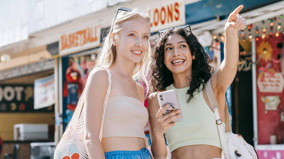 two women in green sleeveless crop top shirt holding mobile phone