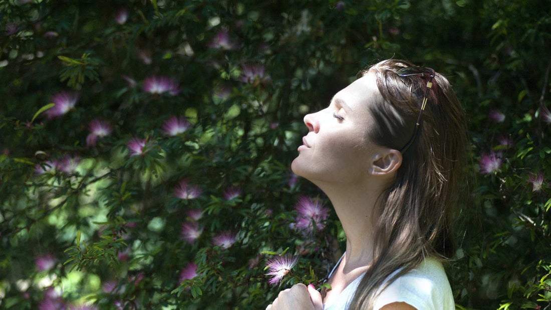 woman standing in front of a bush