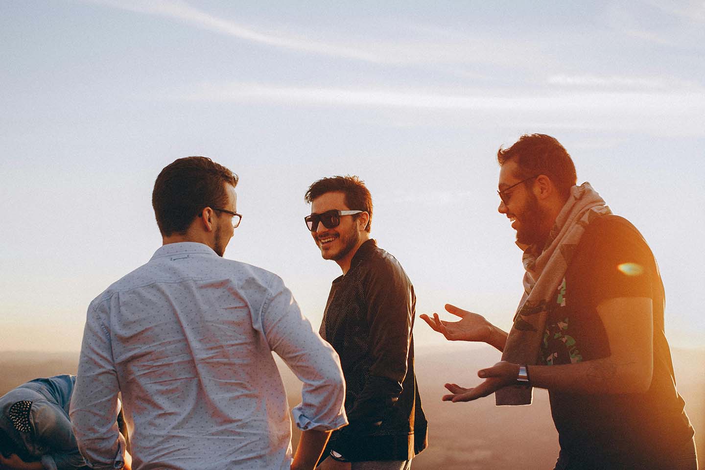 Three men talking and laughing