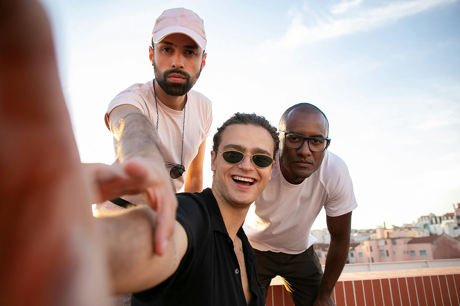 group of men happily taking a photo on roof