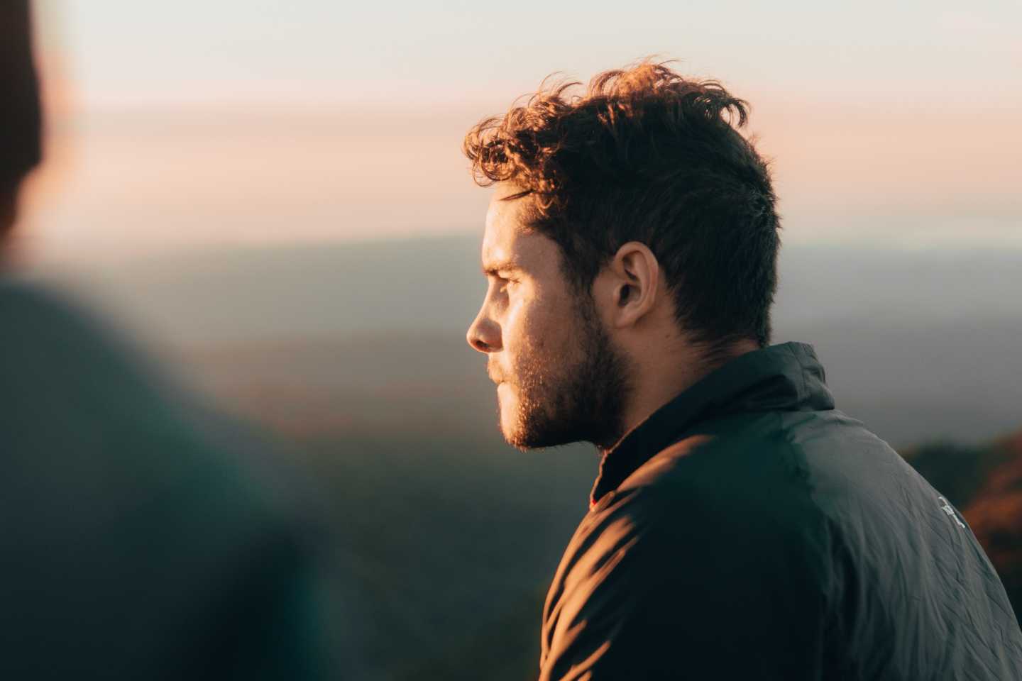 man gazes at the sunset