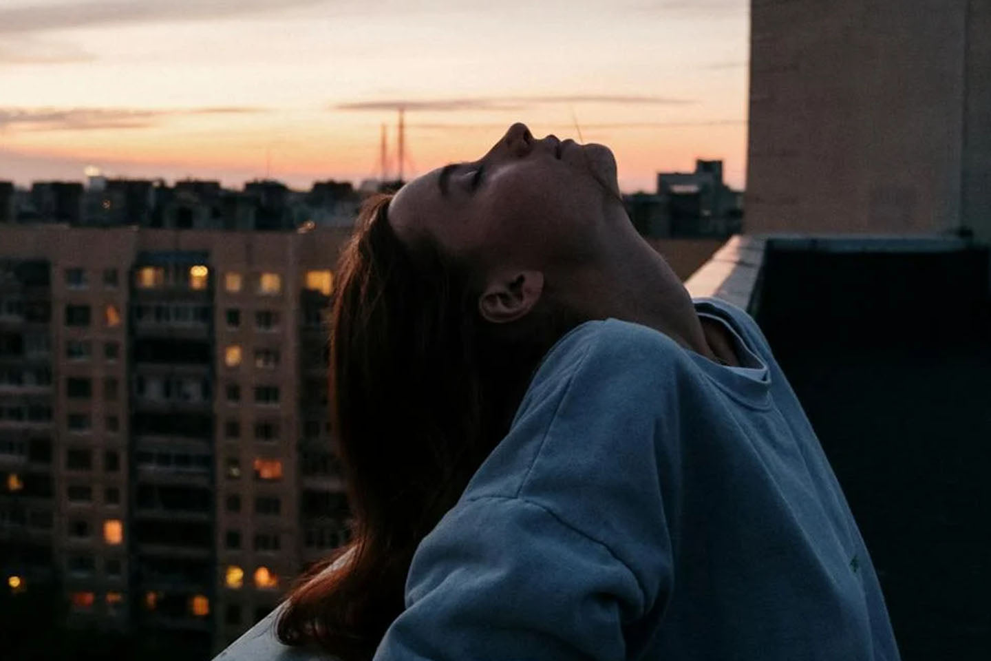 Woman relaxing on the roof of a building