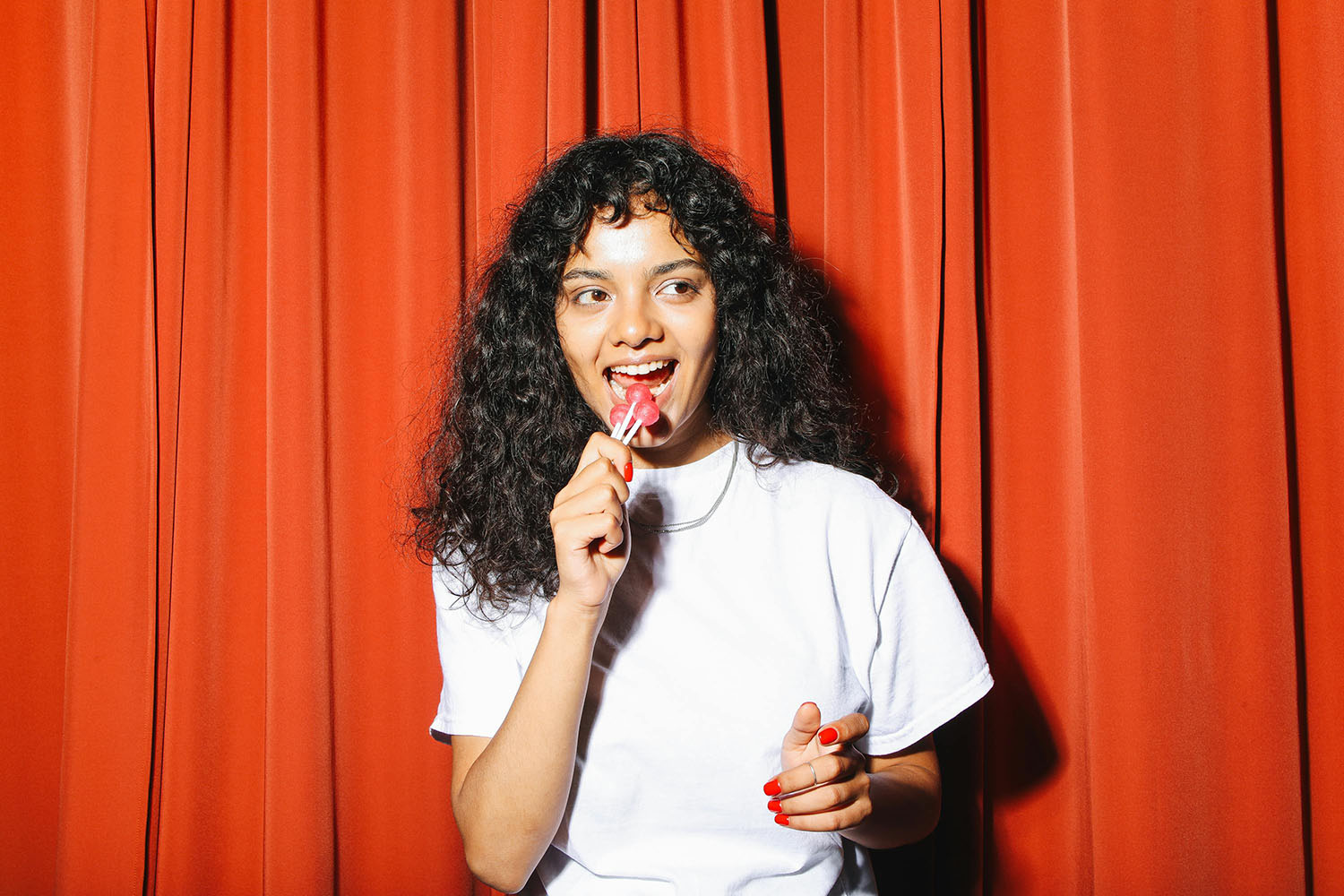 woman holding three lollipops near her mouth