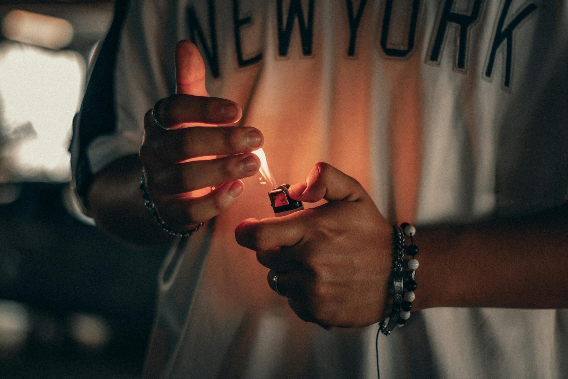 Person holding a lit lighter