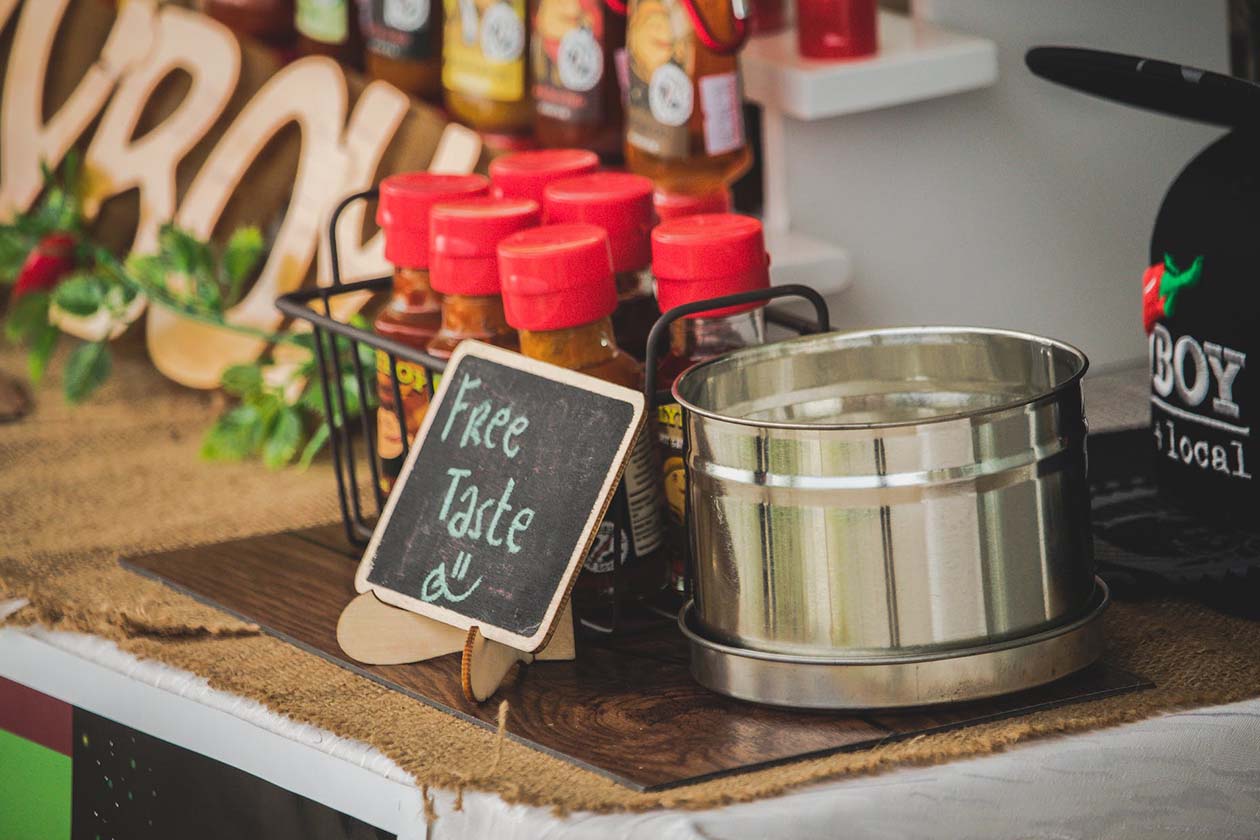 free taste chalkboard signage with condiments at the back