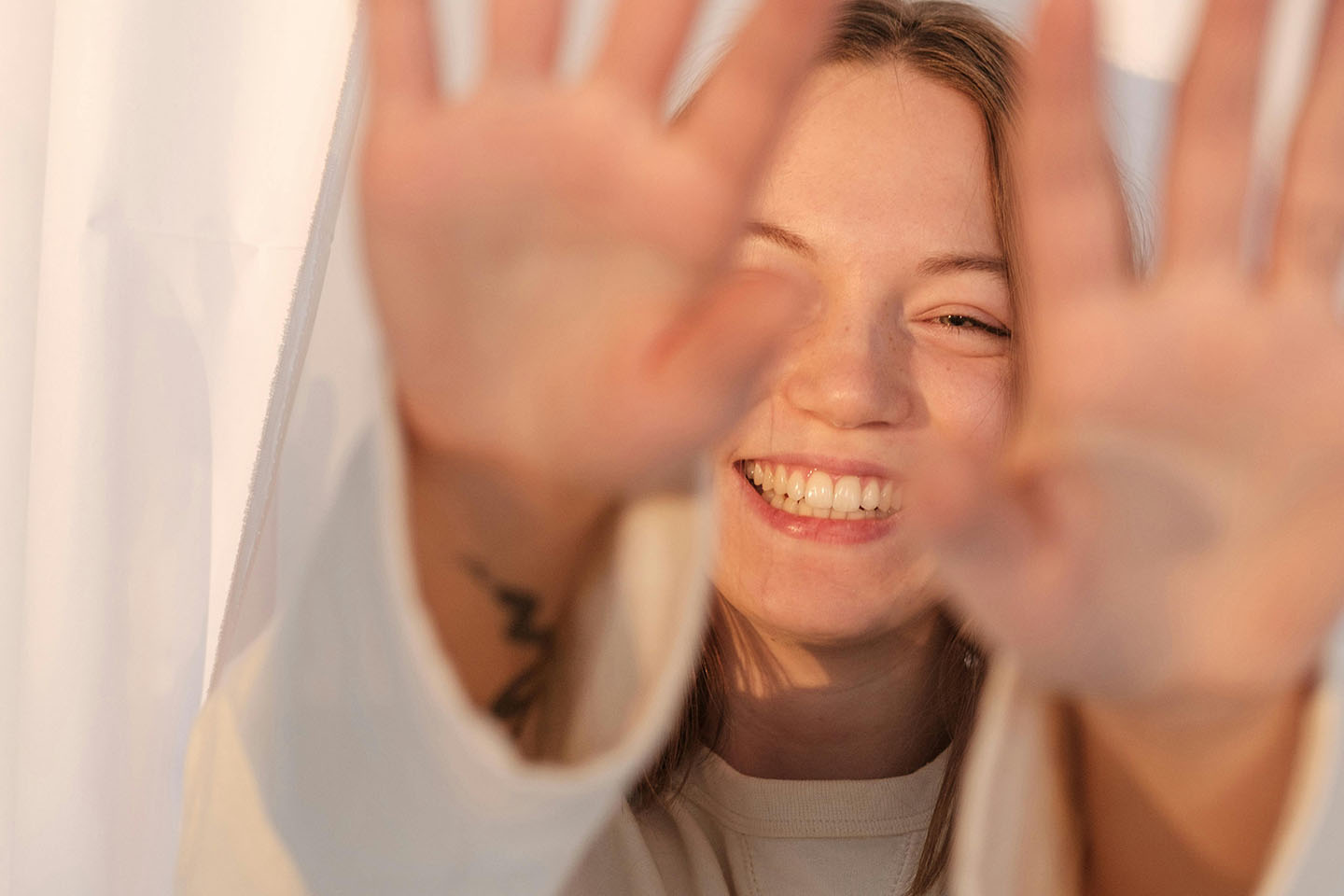 Smiling woman hiding from the camera