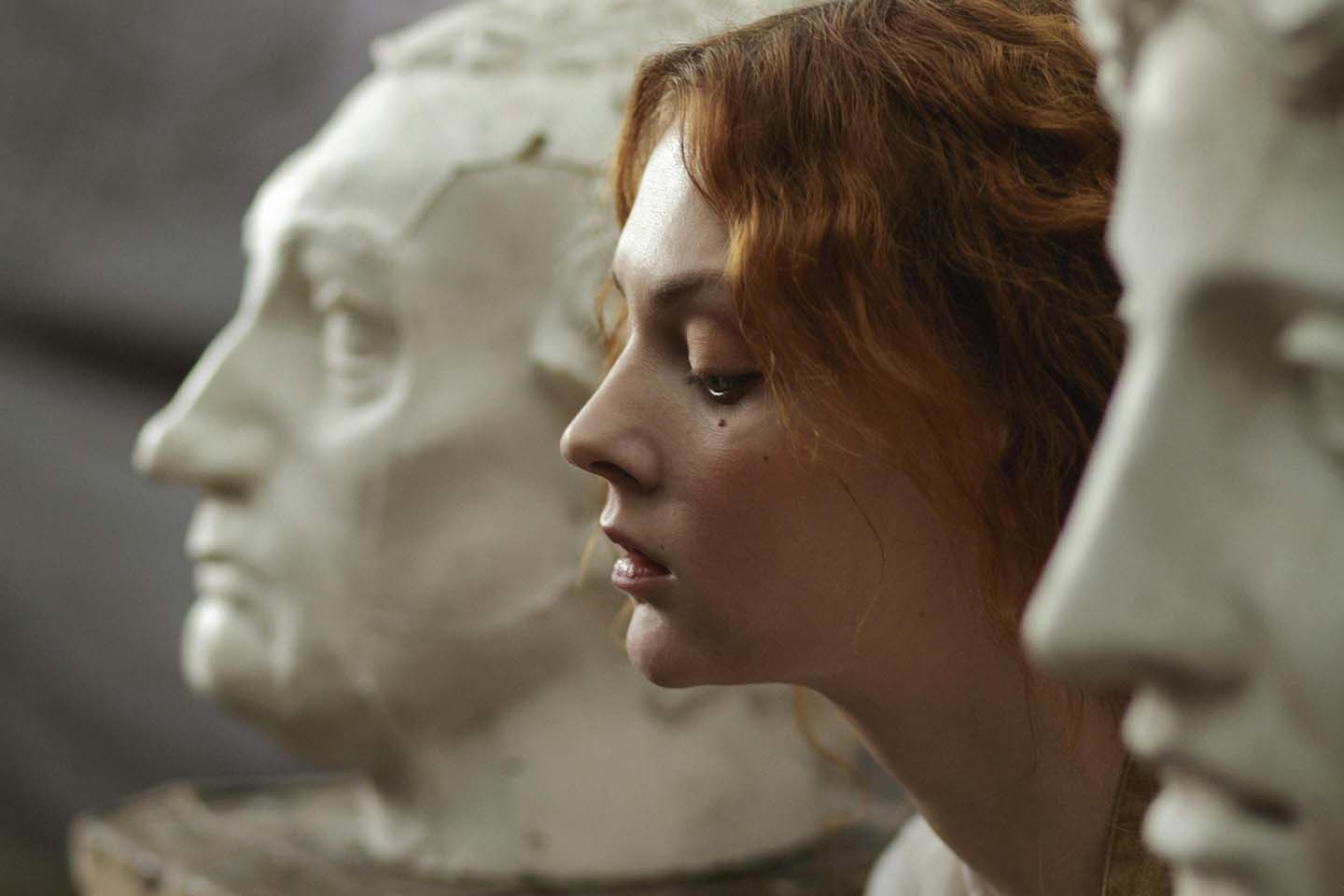 photo of a woman sitting beside statue